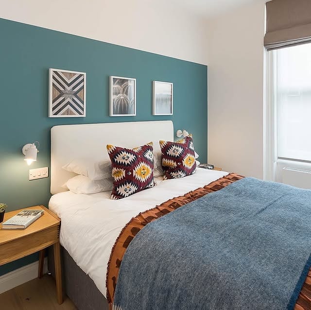 15. Soft Teal Accent Wall With Patterned Textiles - teal bedroom ideas