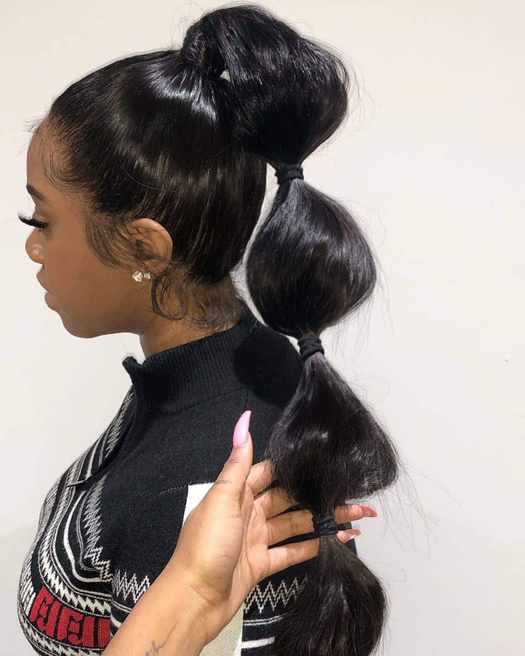 1. Jet Black High Bubble Ponytail - Space Buns Hairstyles