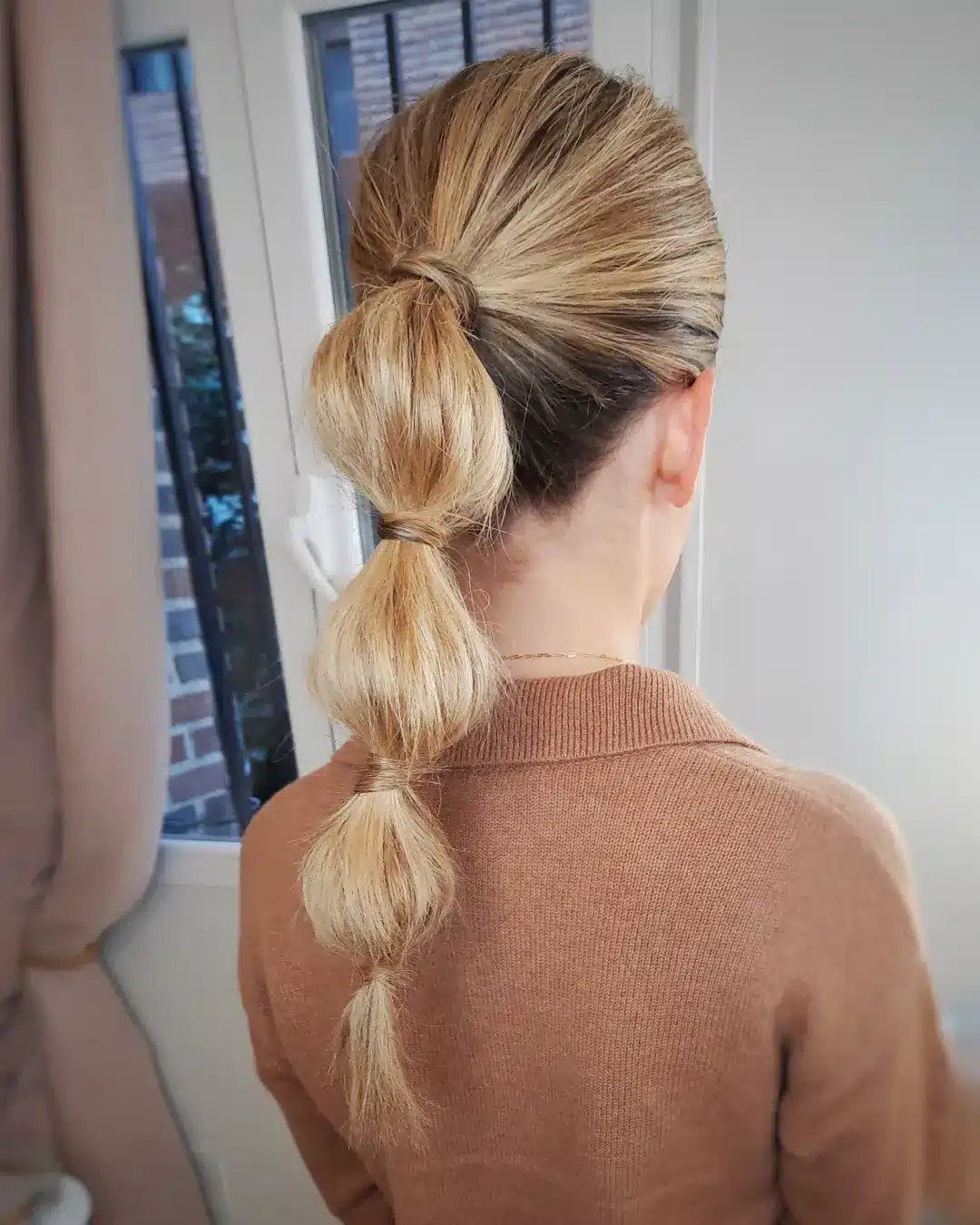 12. Champagne Blonde Low Bubble Ponytail - Space Buns Hairstyles