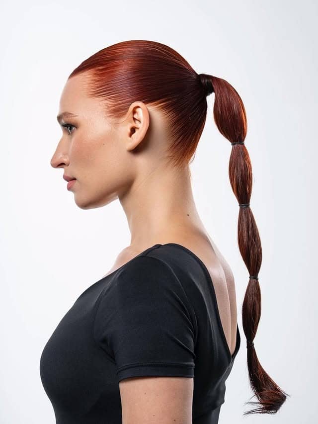 14. Copper Red Sleek Bubble Ponytail - Space Buns Hairstyles