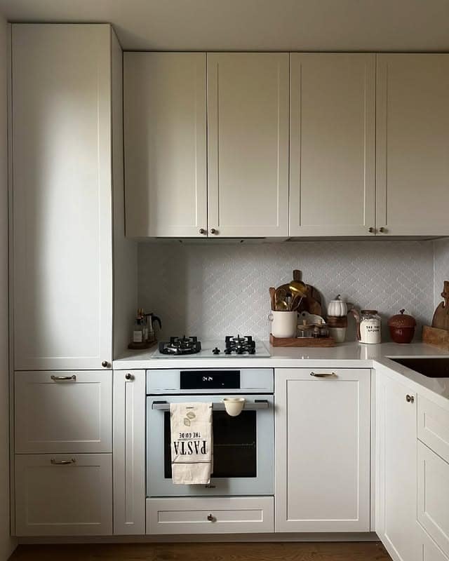 1. Soft White Shaker Kitchen with Ceiling-Height Storage - tiny kitchen ideas