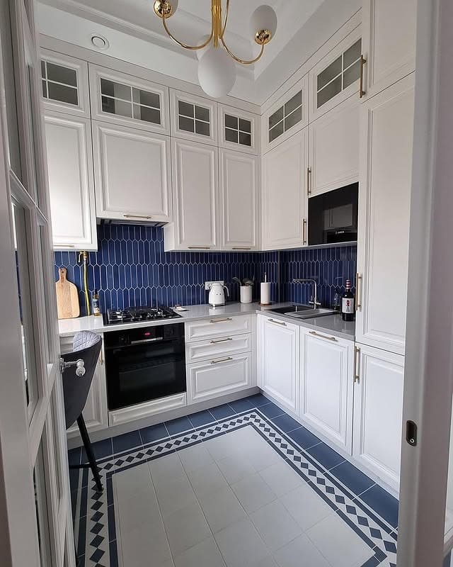 5. Classic White Kitchen with Bold Blue Tile Backsplash - tiny kitchen ideas