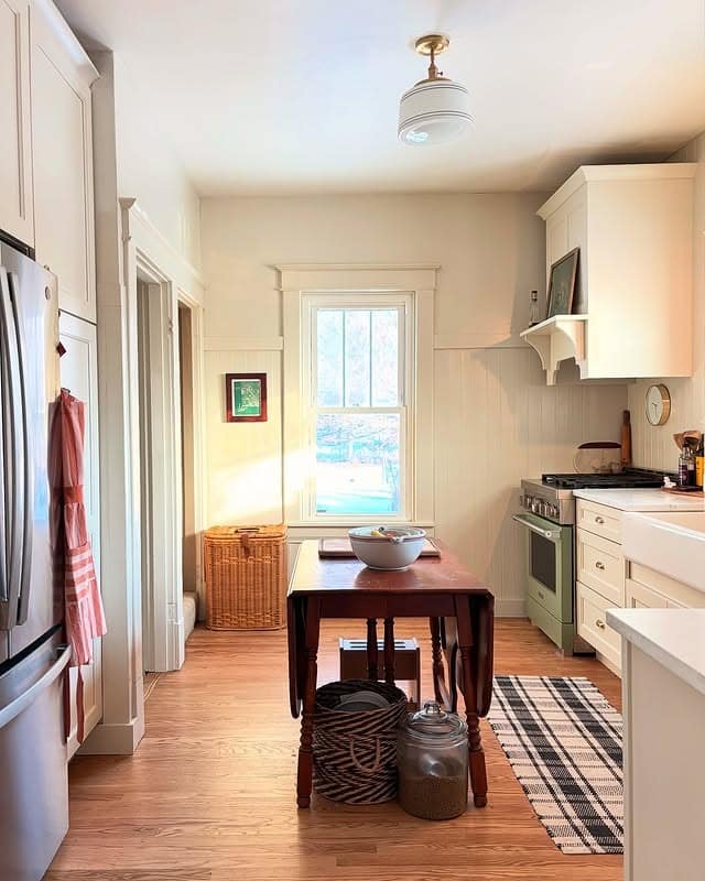 11. Cream Cottage Kitchen with Warm Wood Dining Table - tiny kitchen ideas