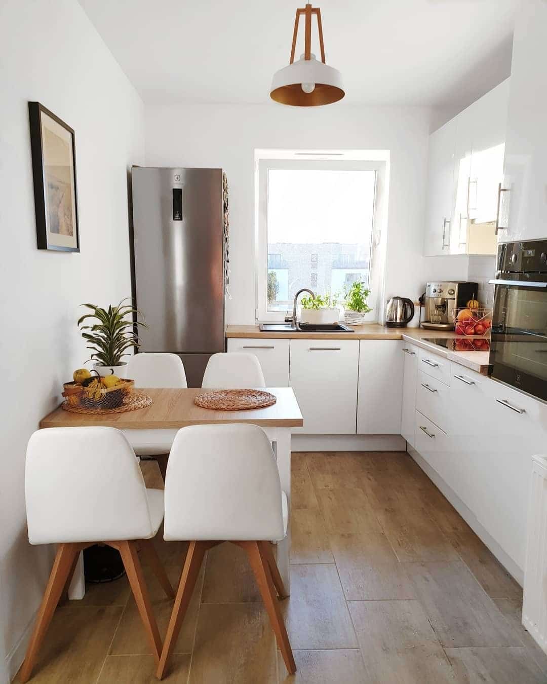 19. Scandinavian White Kitchen with Natural Wood Dining Area - tiny kitchen ideas