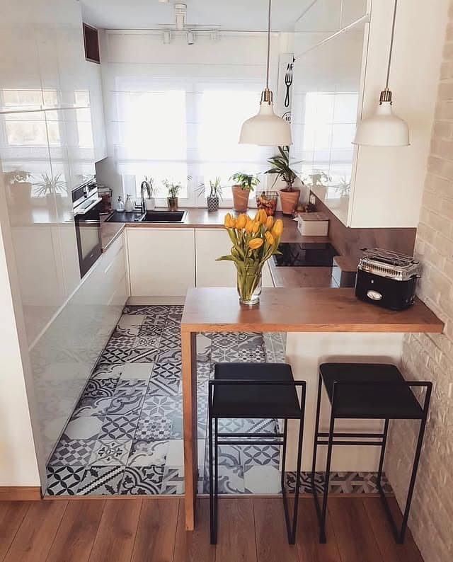 22. Glossy White Kitchen with Wood Breakfast Bar and Patterned Tile Floor - tiny kitchen ideas