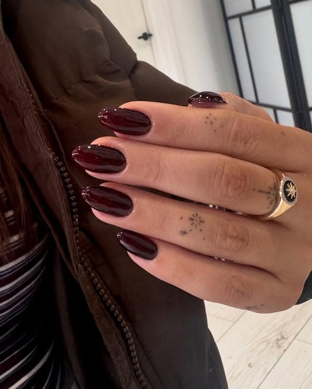 16. Dark Burgundy Glossy Almond Nails - burgundy nail ideas