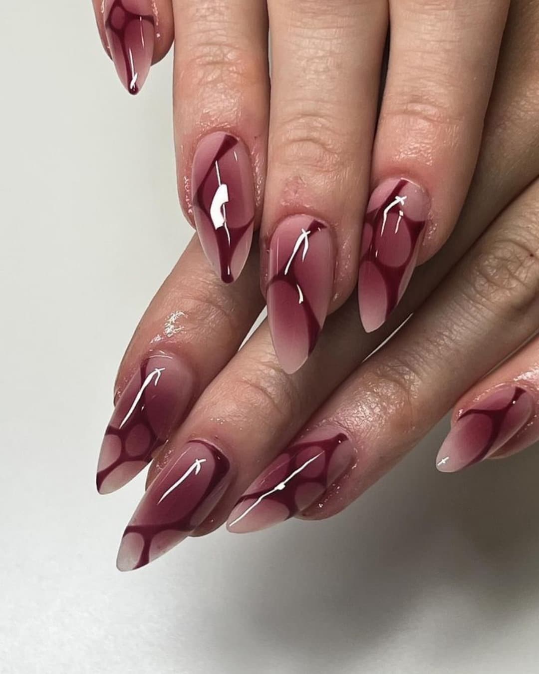 18. Abstract Burgundy Swirl Almond Nails - burgundy nail ideas