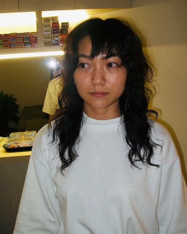 20. Soft Black Curly Shag with Wispy Bangs - Shaggy Haircuts