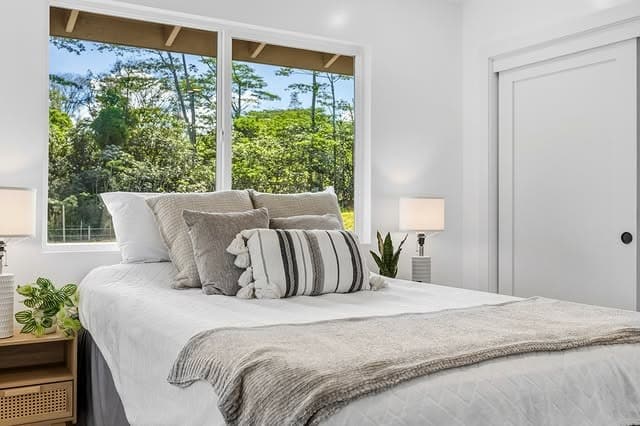 3. Tropical Minimalist Bedroom with White and Sand Tones - hawaiian bedroom ideas