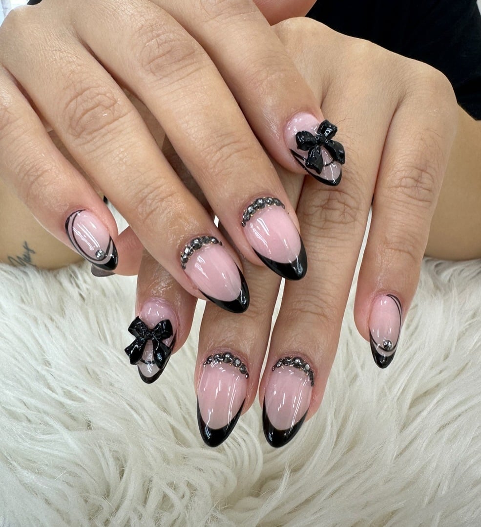 4. Black French Bow Accent Almond Nails - elegant nail ideas