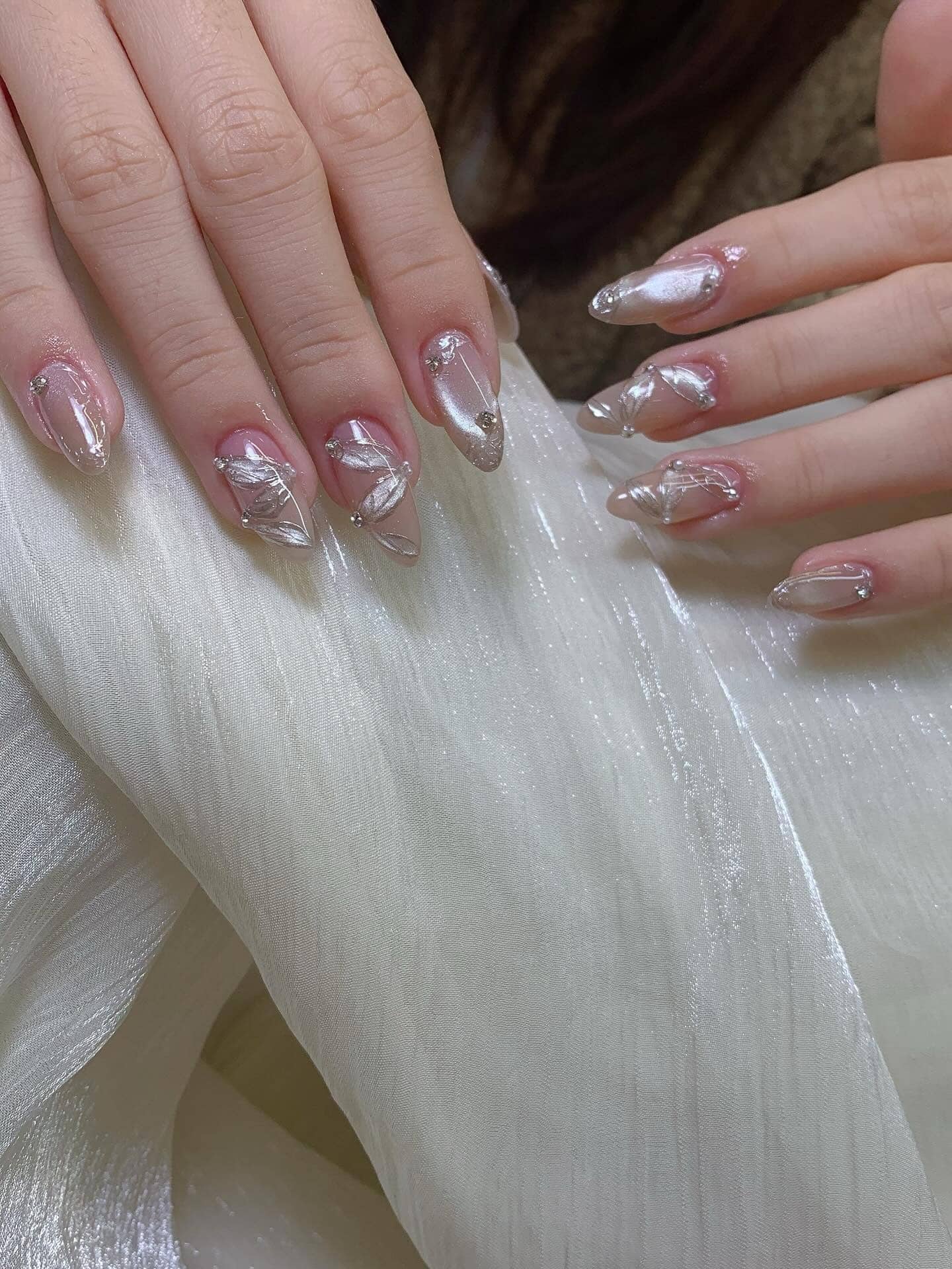 15. Silver Chrome Floral Almond Nails - elegant nail ideas