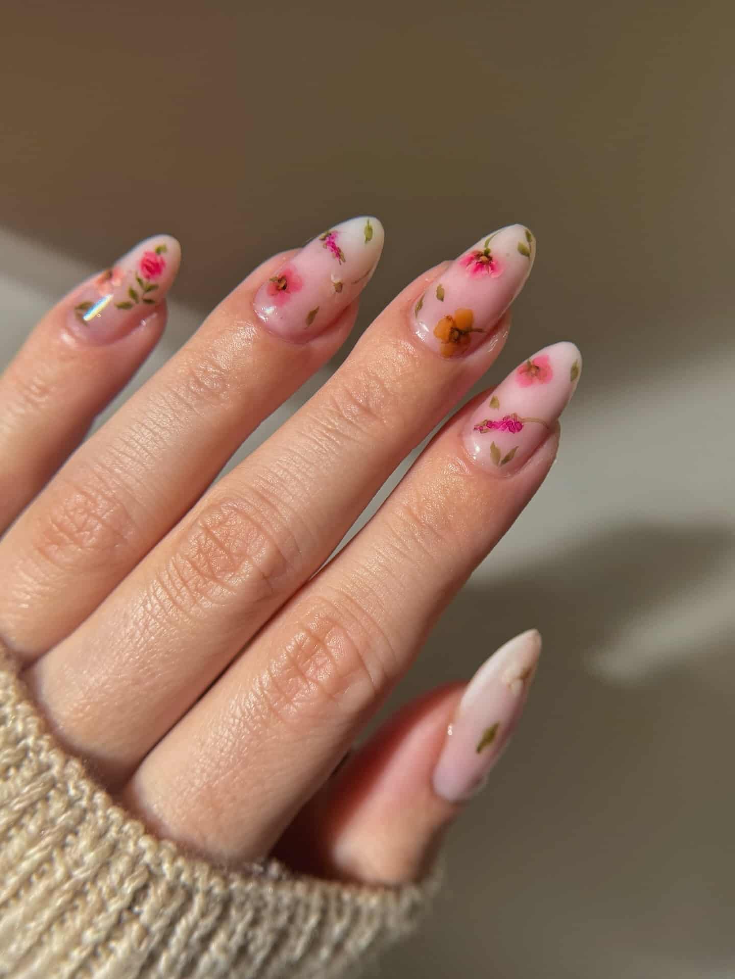 5. Pressed Flower Nails with Soft Pink Ombre Finish - floral nail ideas