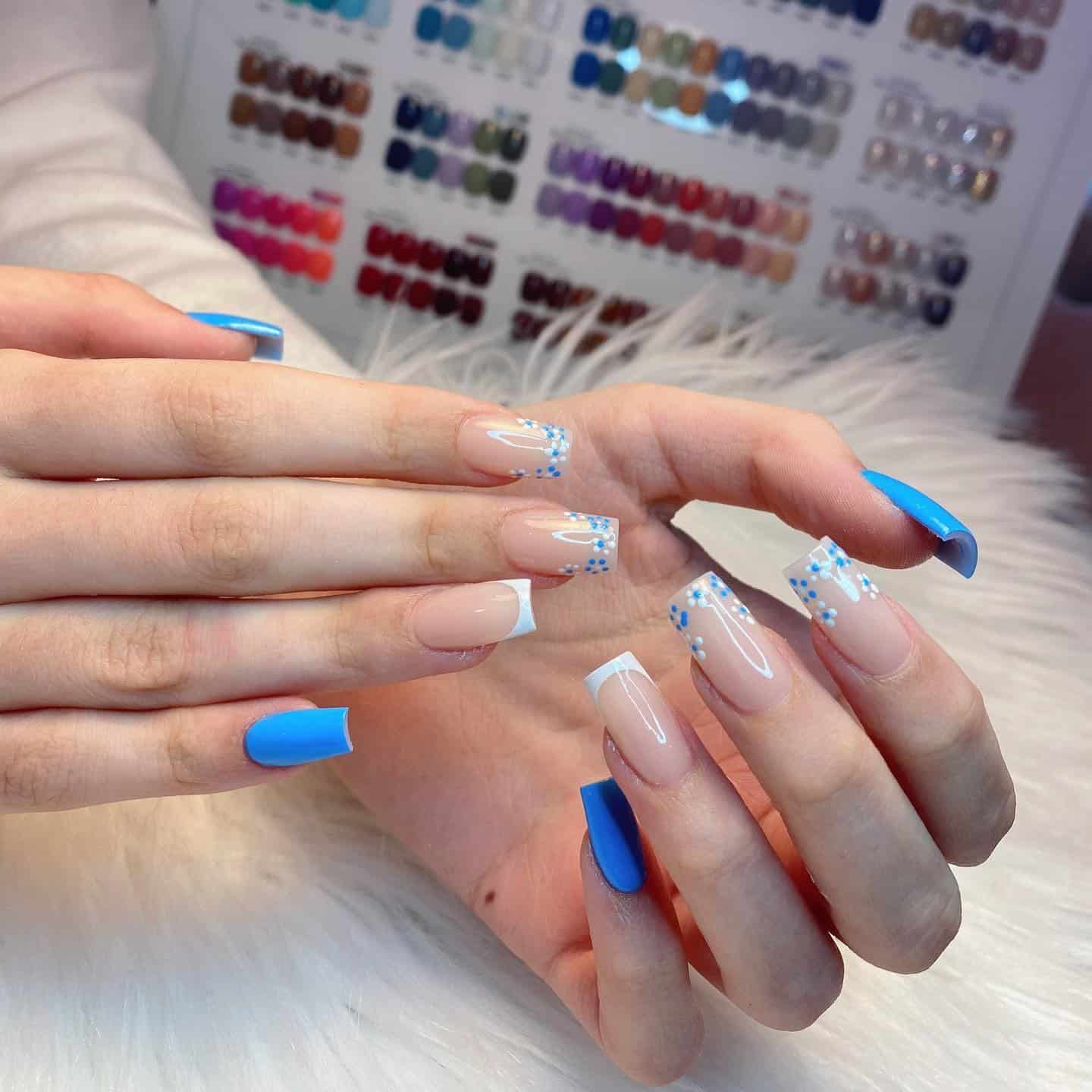 6. Blue Daisy French Tip Nails with Glossy Nude Base - floral nail ideas