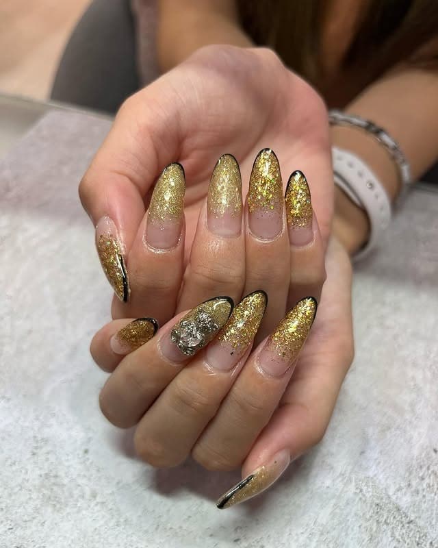 10. Gold Foil and Glitter Almond Nails - gold nail ideas