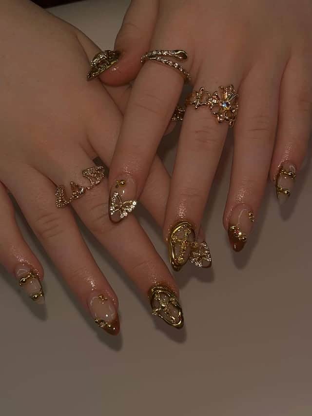 20. Gold Butterfly Accent Almond Nails - gold nail ideas