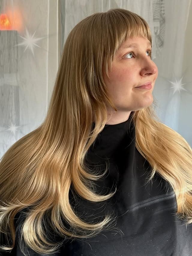 7. Long Feathered Hair with Straight Micro Fringe and Golden Blonde Color - Long Wispy Haircuts