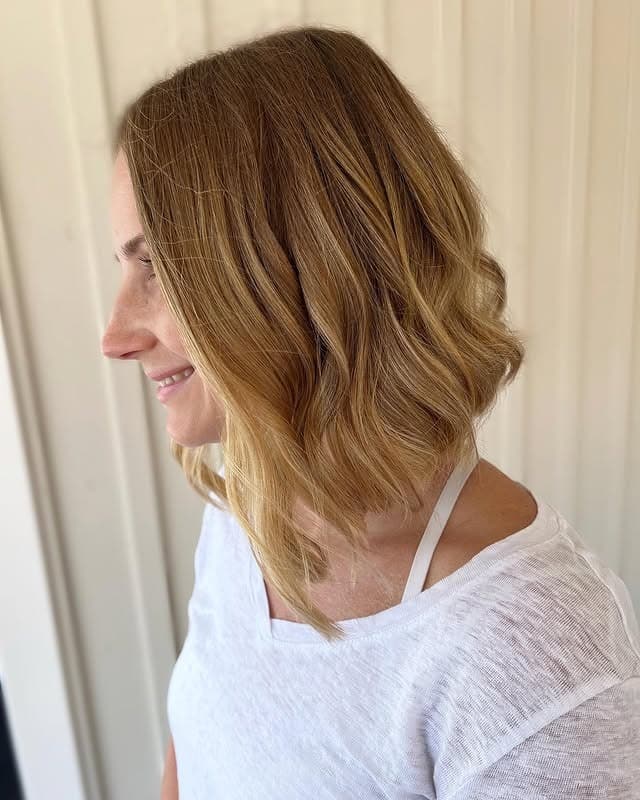 5. Wavy Honey Blonde Angled Lob - Angled Lob Haircut