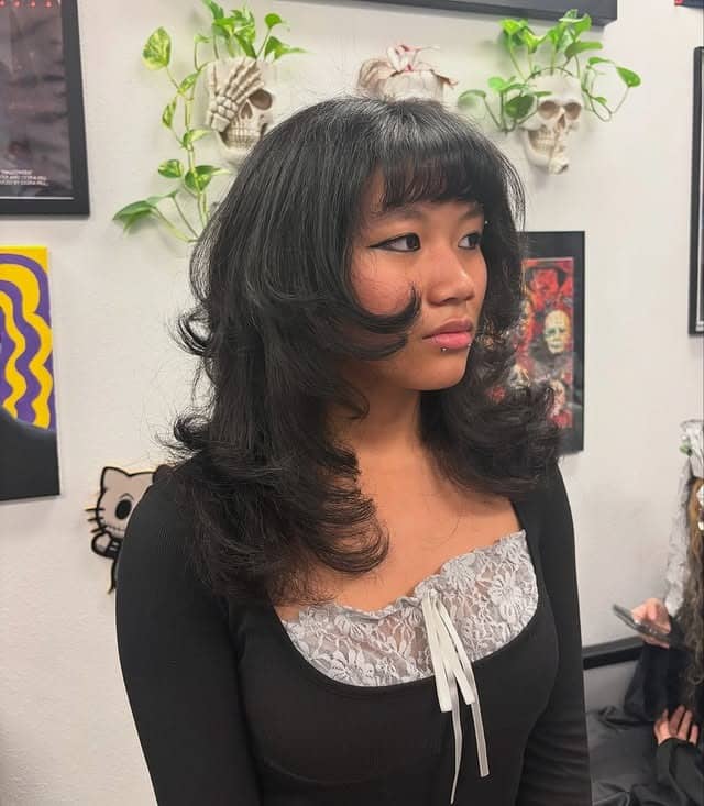 4. Rounded Shag Layers with Soft Black Wispy Fringe - Layered Hair With Wispy Bangs