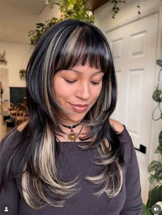 11. Layered Midnight Black Hair with Platinum Money Piece Highlights and Wispy Bangs - Layered Hair With Wispy Bangs