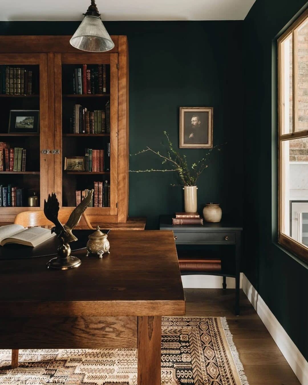 2. Moody Dark Green Study with Warm Wood Furniture - dark green office ideas