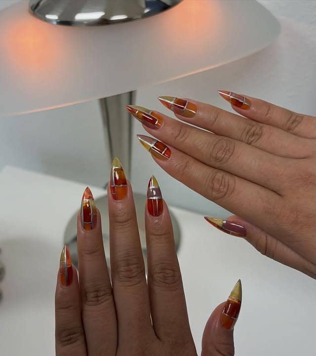 11. Amber Glass Chrome Stiletto Nails - stiletto nail ideas