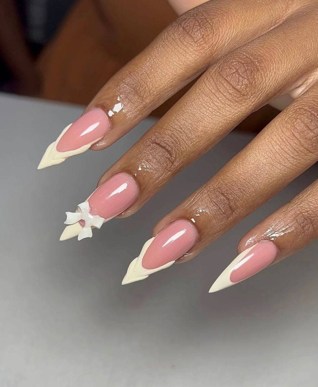 21. Blush Pink and Ivory Bow Stiletto Nails - stiletto nail ideas
