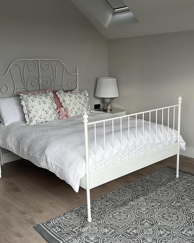 1. White Iron Bed Girls Bedroom with Soft Floral Accents - girls bedroom ideas