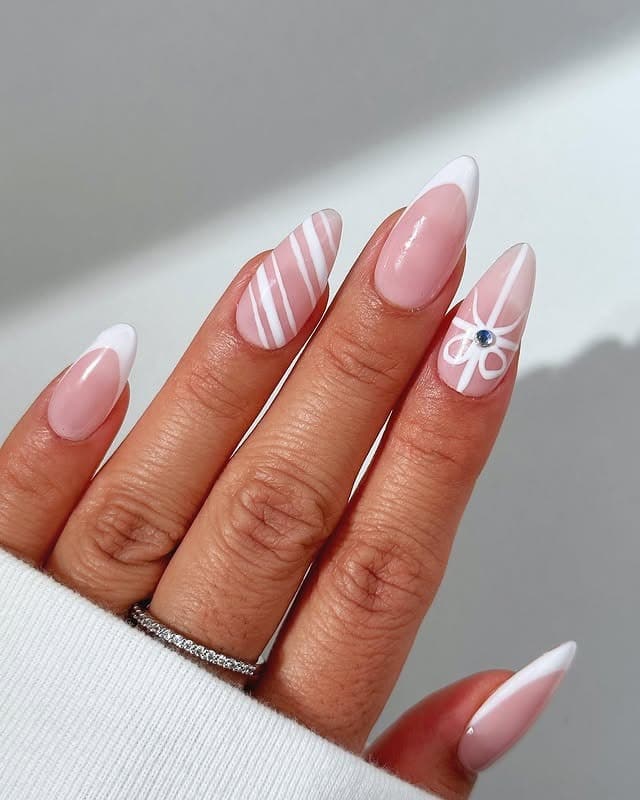 11. White French Tip Almond Nails with Bow Accent - white tip nail ideas