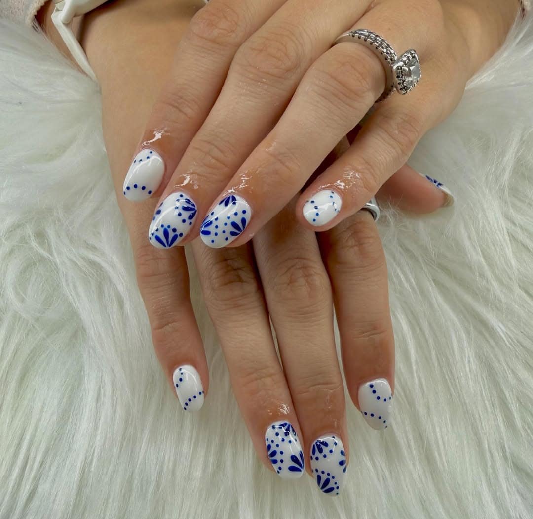 5. Blue and White Coastal Pattern Almond Nails - beach nail ideas