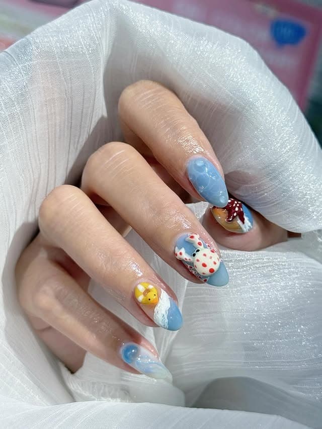 12. Baby Blue Ocean Charm Almond Nails - beach nail ideas