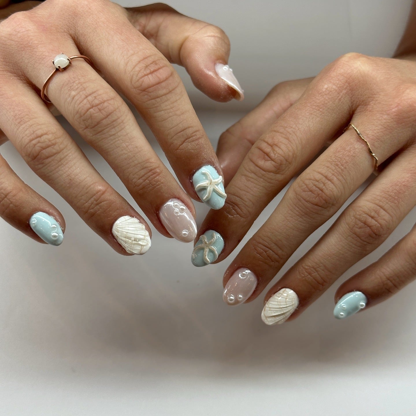 13. Pastel Blue Seashell and Starfish Nails - beach nail ideas