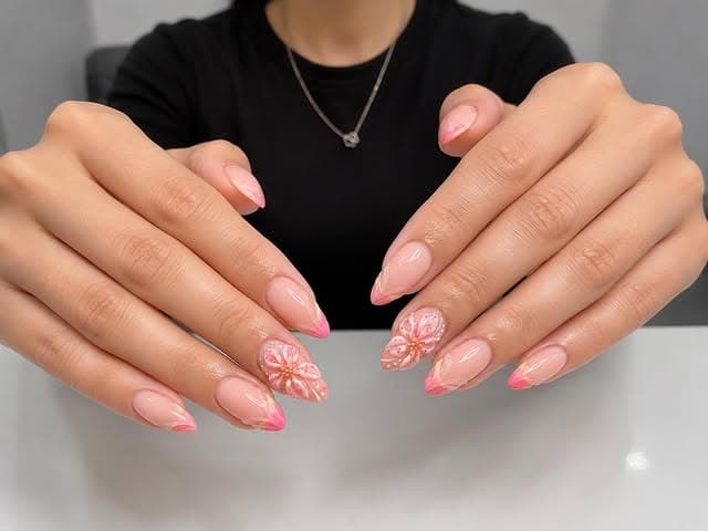 5. Pink Ombre Almond Nails with Floral Accent Design - holiday nail ideas