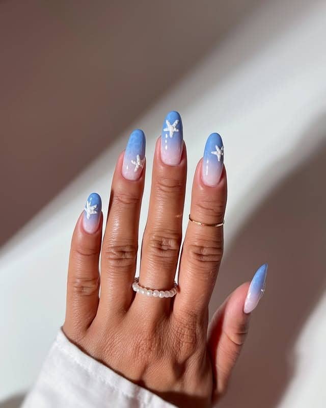 10. Blue Ombre Almond Nails with White Starfish Art - holiday nail ideas