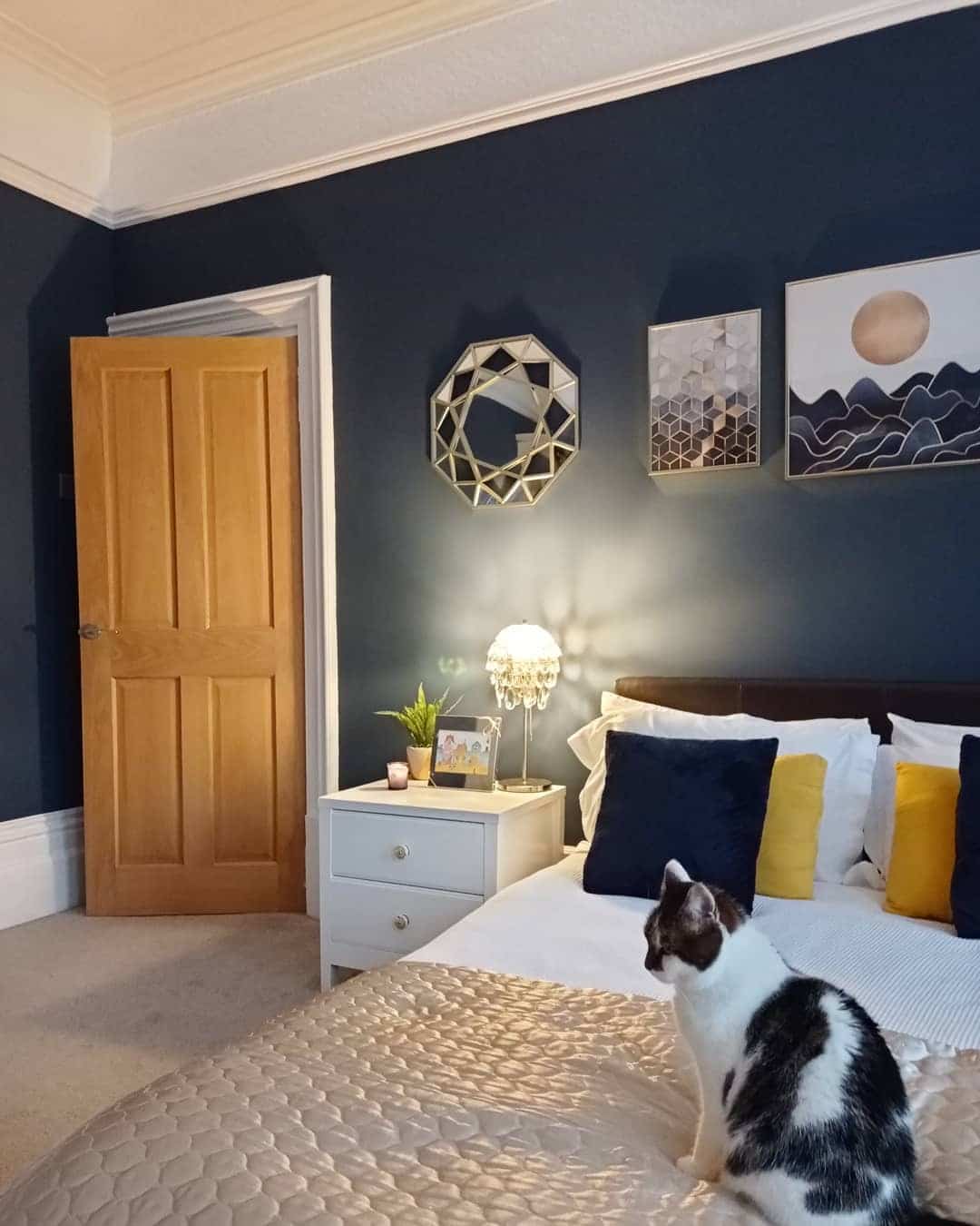 11. Navy Feature Wall with Gold Accent Styling - navy bedroom ideas