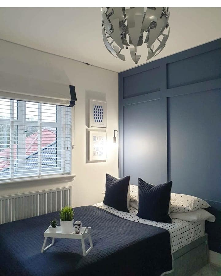 14. Modern Navy Panel Wall Bedroom Design - navy bedroom ideas