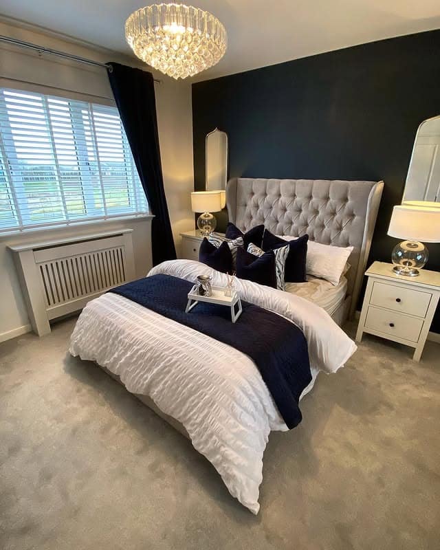 17. Navy Accent Wall with Glamorous Crystal Lighting - navy bedroom ideas