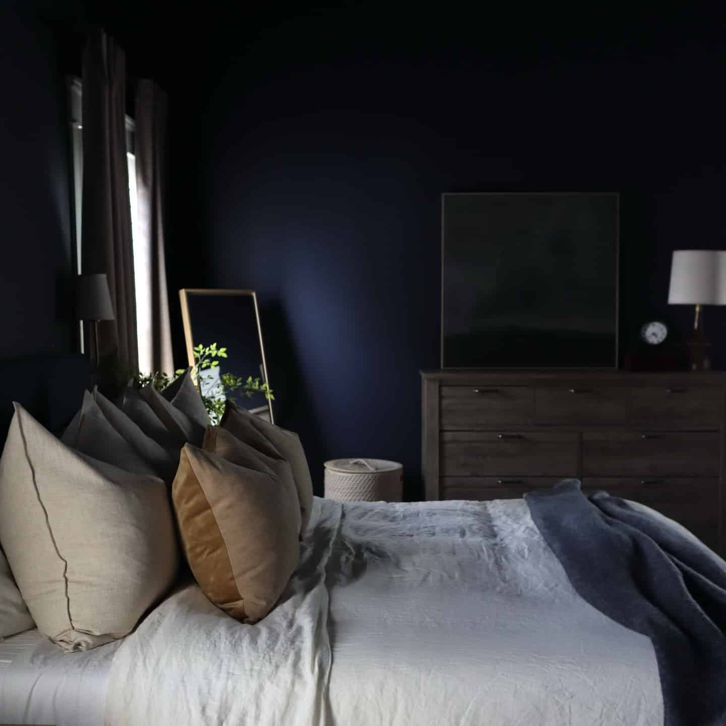 19. Dark Navy Bedroom with Warm Neutral Layers - navy bedroom ideas