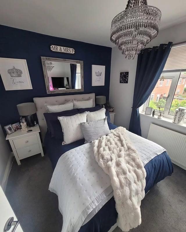 20. Classic Navy and White Bedroom with Statement Chandelier - navy bedroom ideas