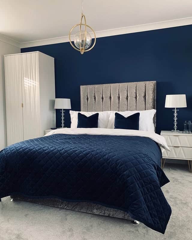 21. Navy Accent Wall with Silver Glam Furnishings - navy bedroom ideas