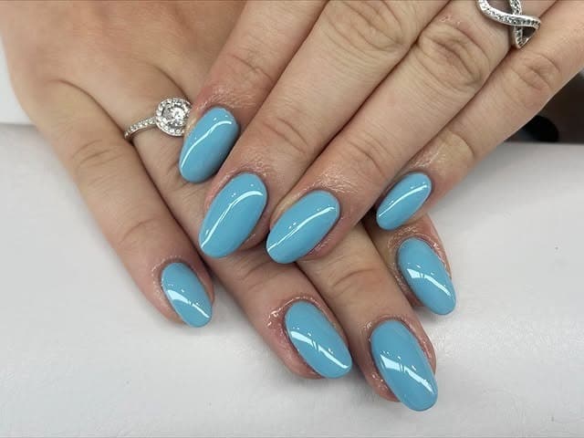 9. Classic Glossy Baby Blue Oval Nails - light blue nail ideas