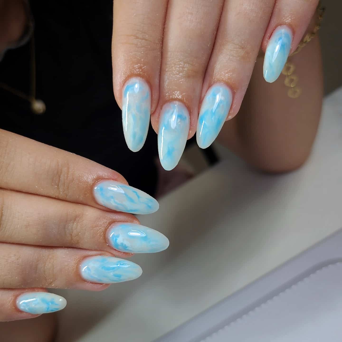 15. Cloud Marble Light Blue Almond Nails - light blue nail ideas