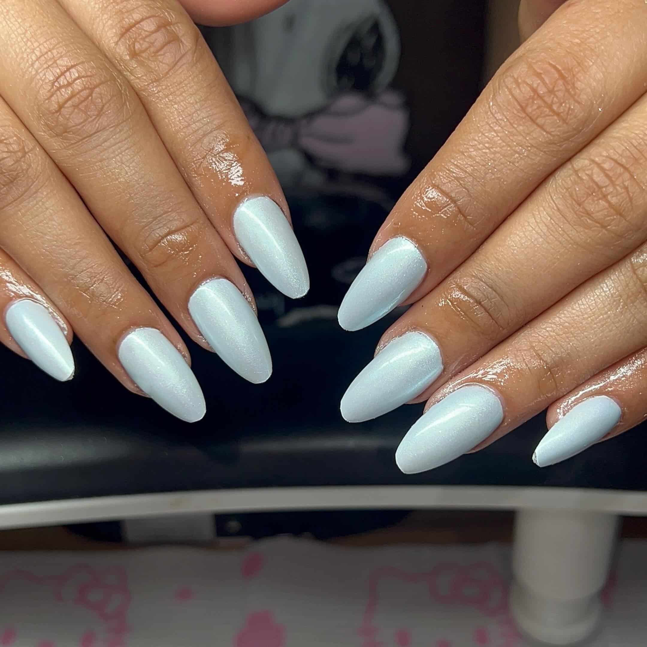 16. Pearlescent Ice Blue Almond Nails - light blue nail ideas