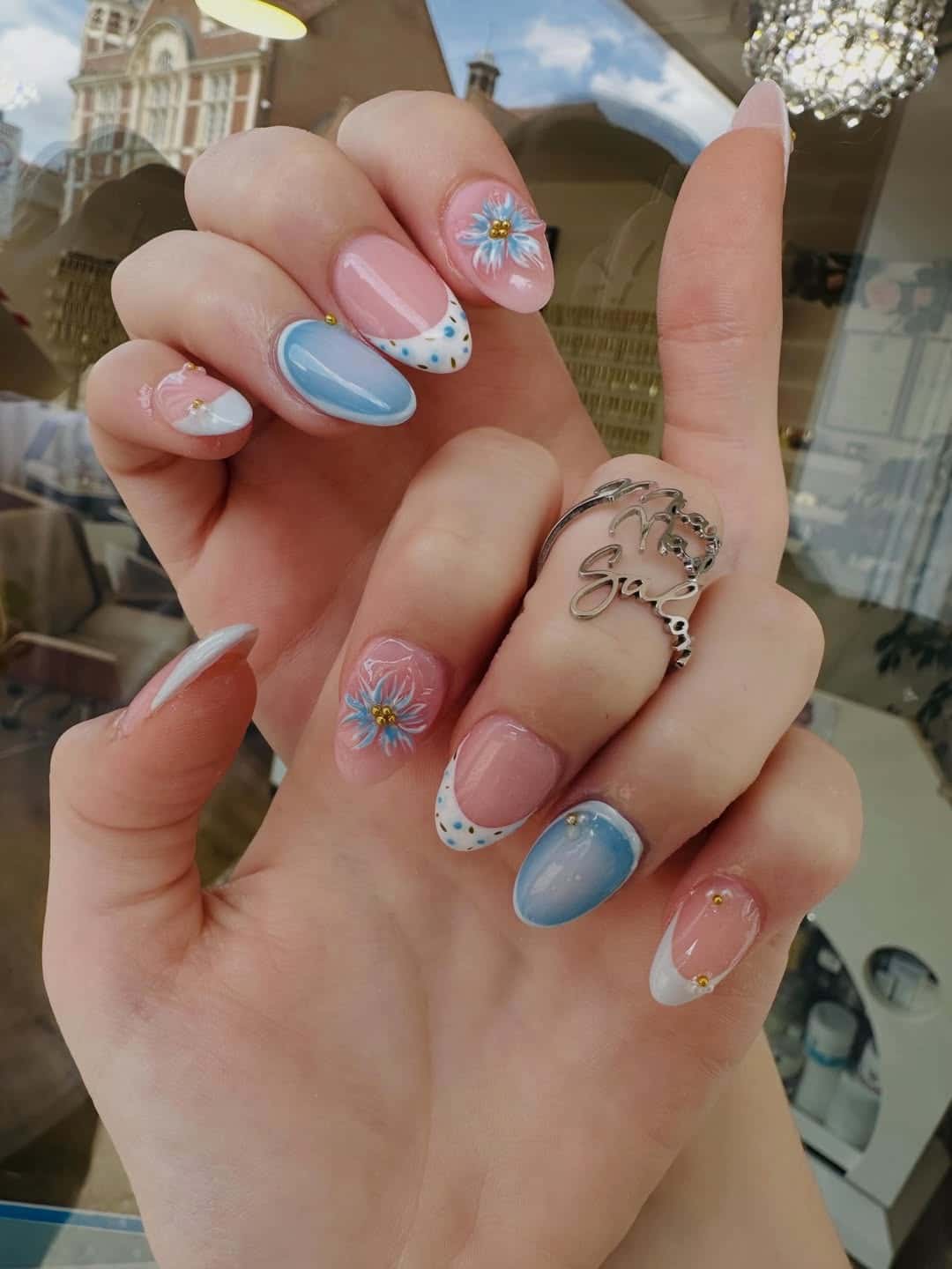 17. Floral Light Blue French Tip Almond Nails - light blue nail ideas