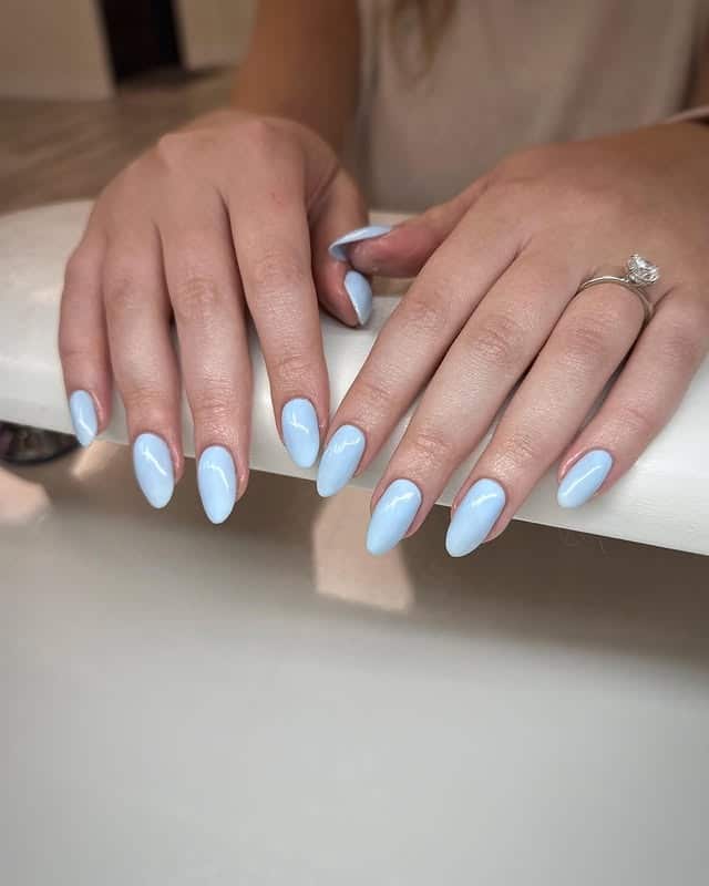 22. Glossy Pastel Light Blue Almond Nails - light blue nail ideas