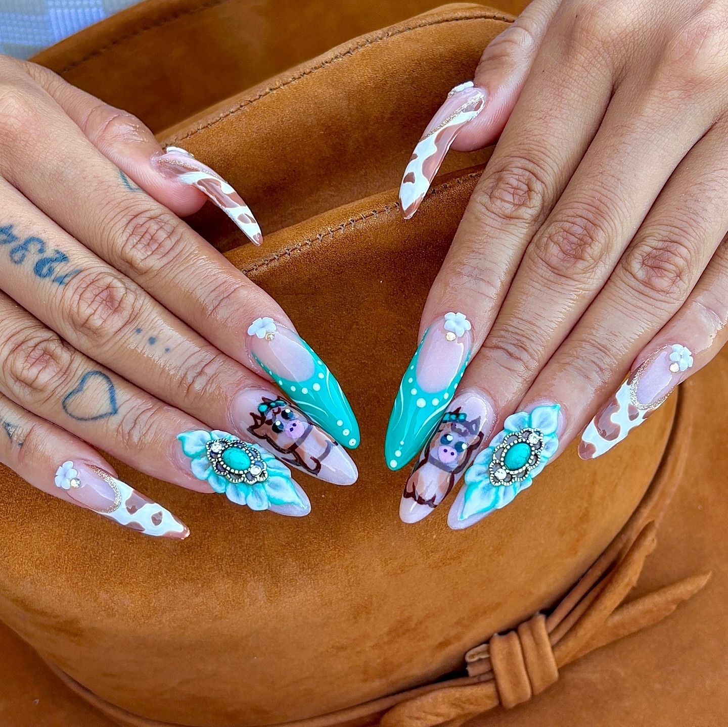 1. Turquoise Cow Print Floral Stiletto Nails - long nail ideas