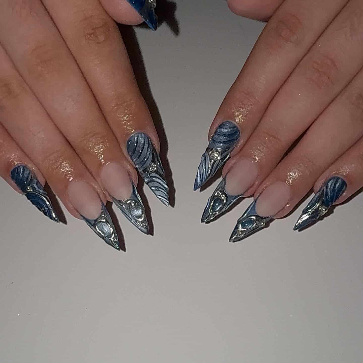 12. Metallic Blue Sculpted Stiletto Nails - long nail ideas