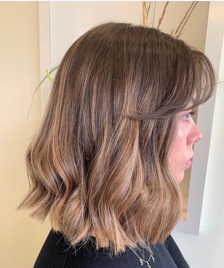 11. Sandy Beige Balayage Midi Cut with Wispy Fringe - Midi Cut Hairstyles