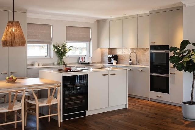 9. Minimalist Beige Kitchen with Warm Wood Flooring - elegant kitchen ideas