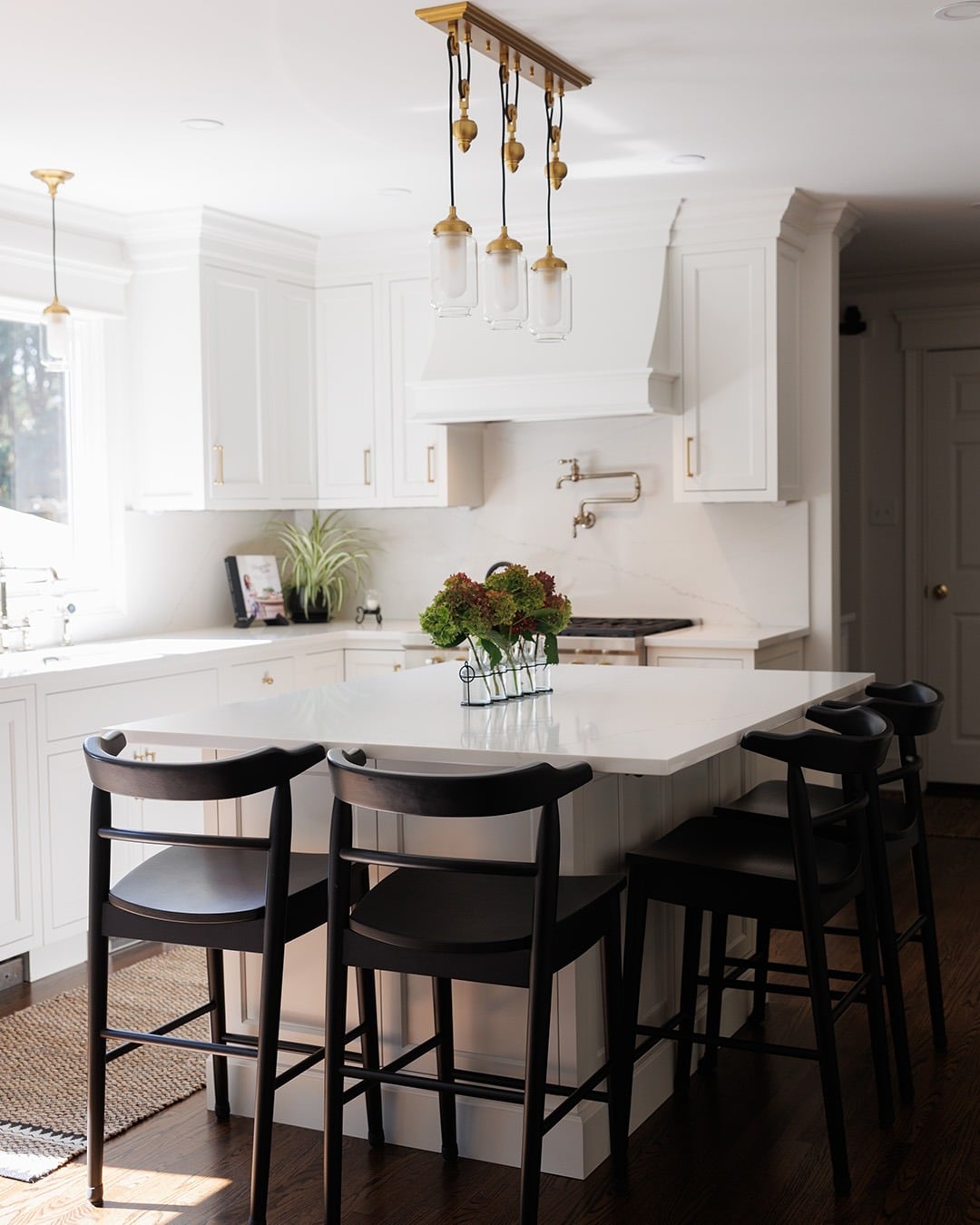 12. Classic White Kitchen with Black Seating Accents - elegant kitchen ideas