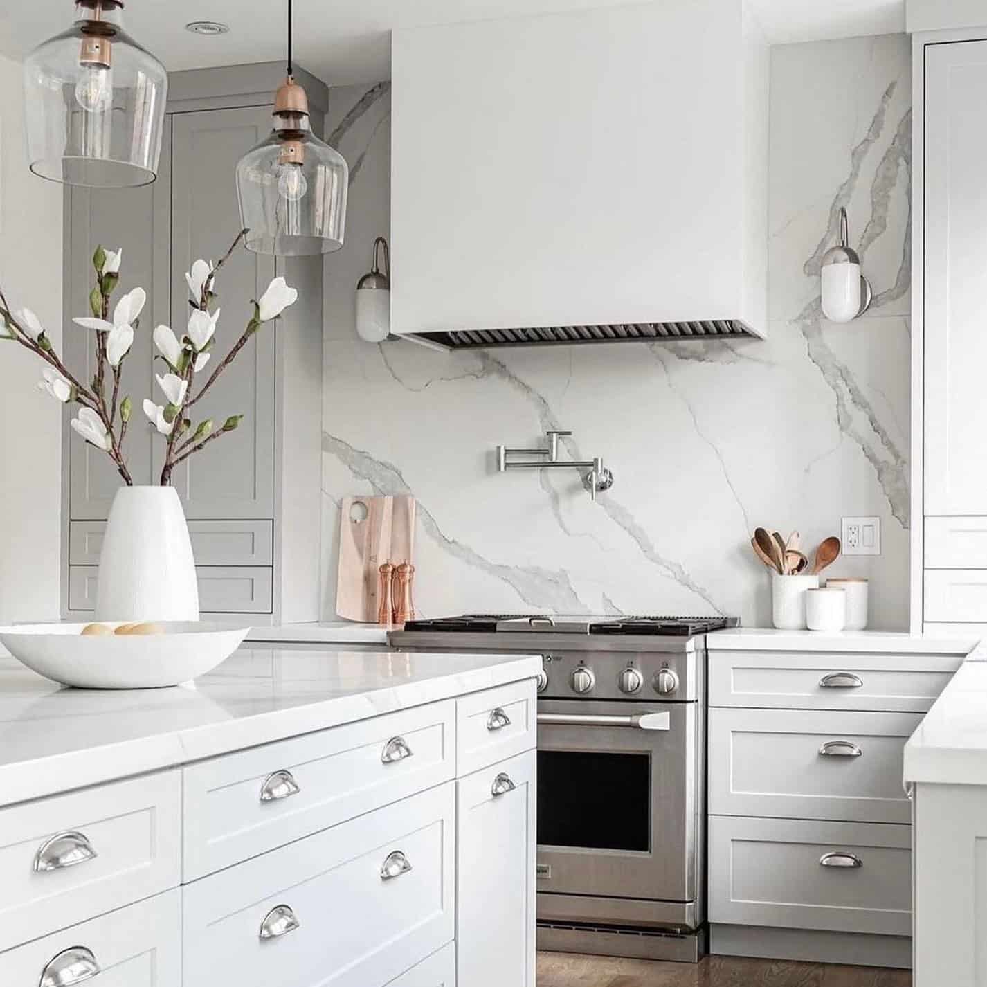 17. White Shaker Kitchen with Marble Veining Accents - elegant kitchen ideas